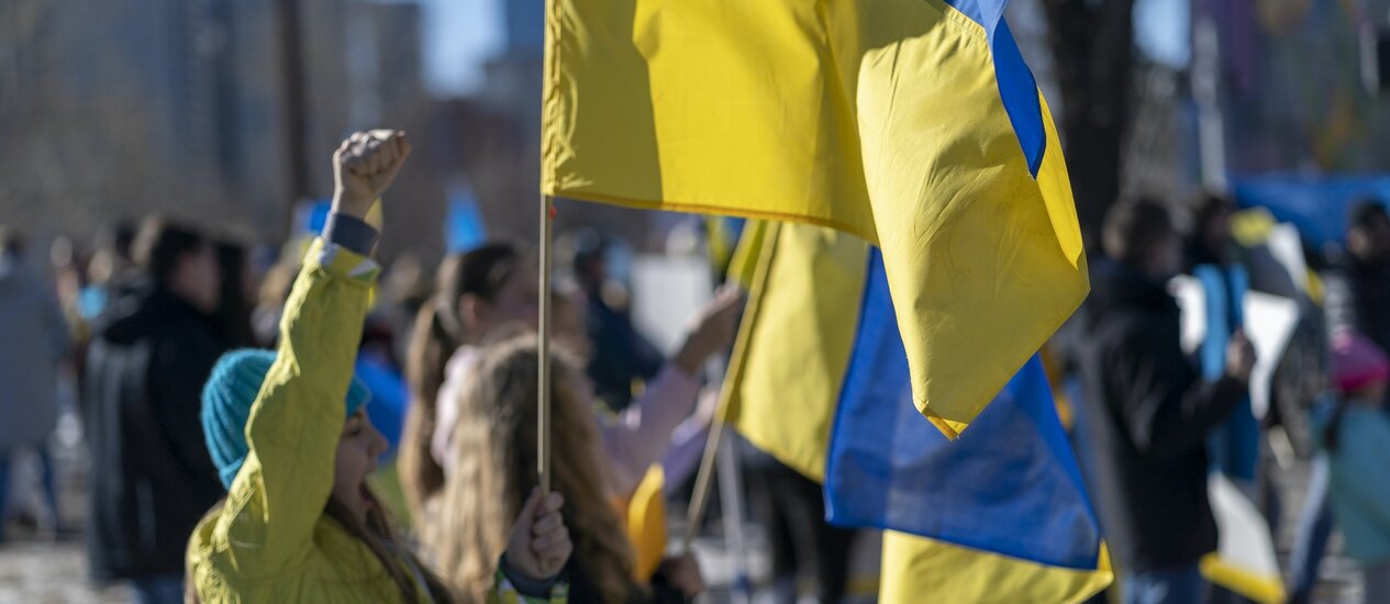 Woman holding Ukrainian flag at protest