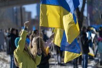 Woman holding Ukrainian flag at protest