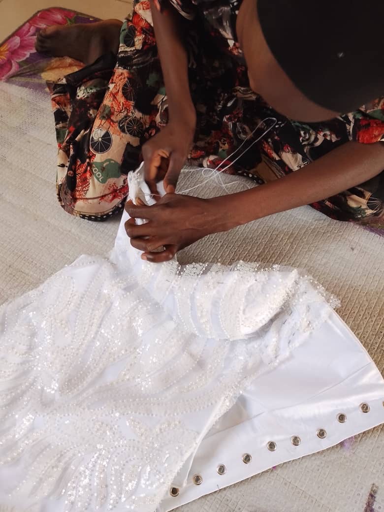 Survivor making her wedding dress with support of her vocational trainer. Nigeria, March 2025. Ussah - GSFUssah Yakubu/GSF